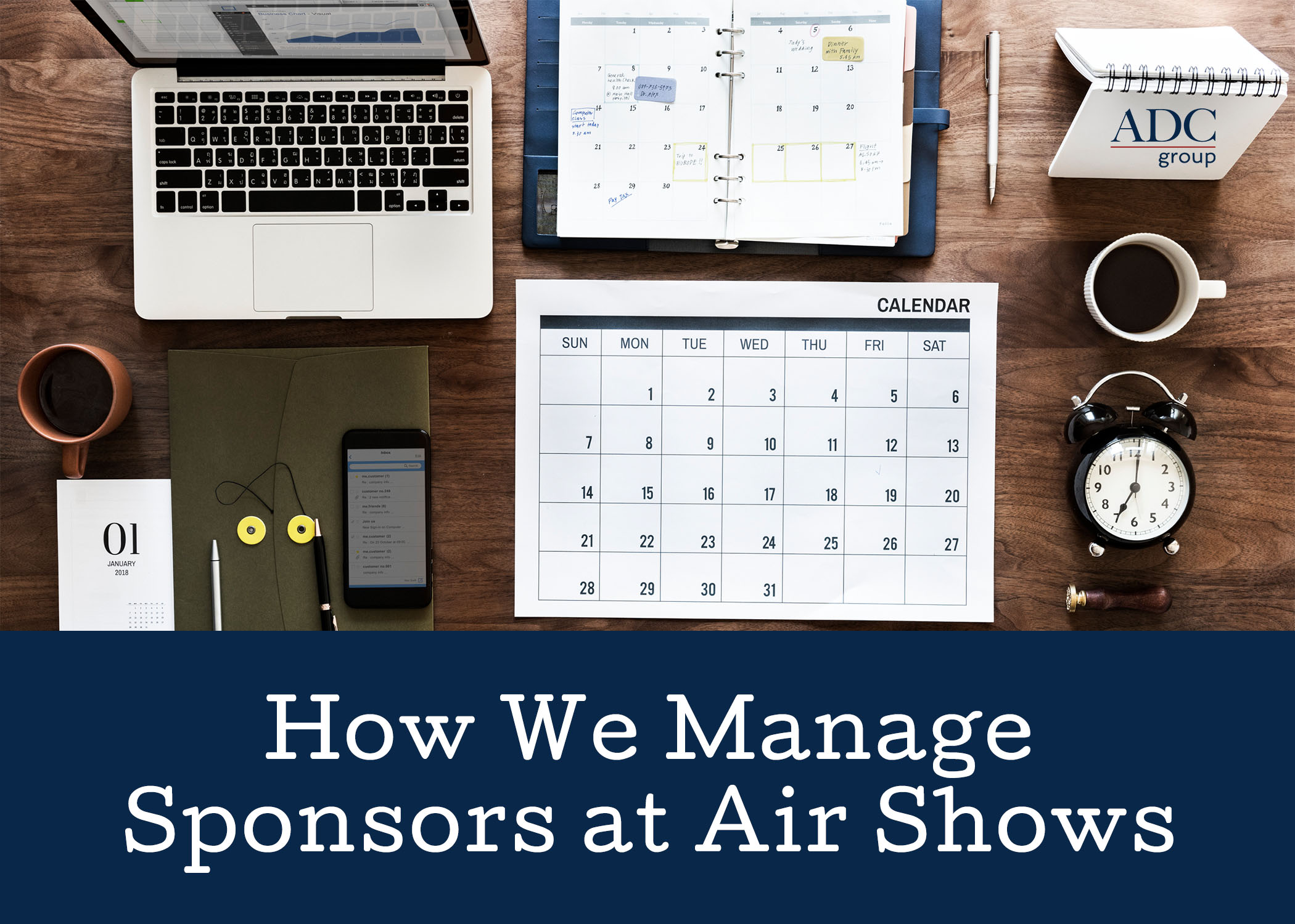 Wooden desktop with laptop, calendar, a cup of coffee, clock and a planner with header text underneath How We Manage Sponsors at Air Shows