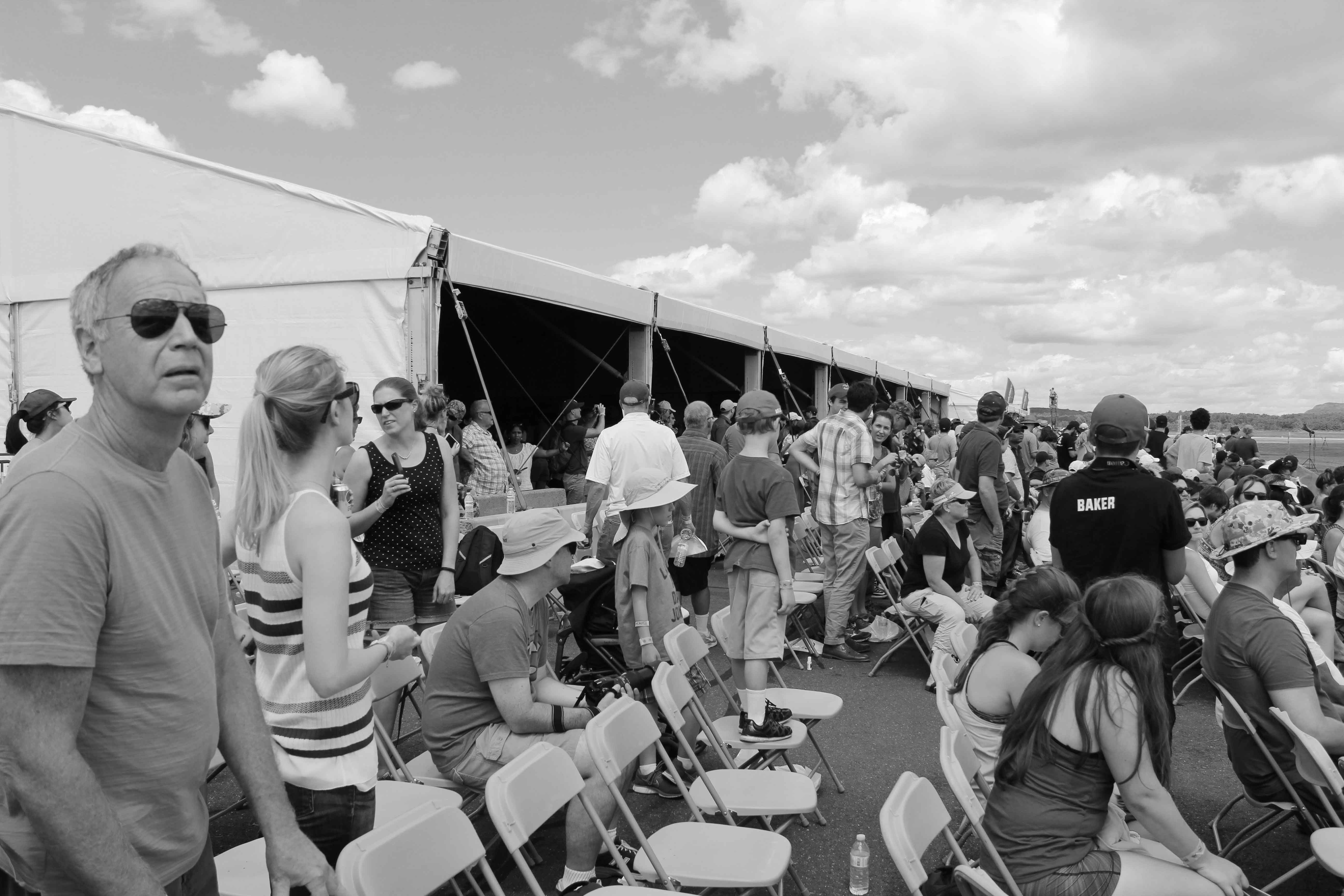 black and white photo of crowd at air show in an employee lodge watching an air show