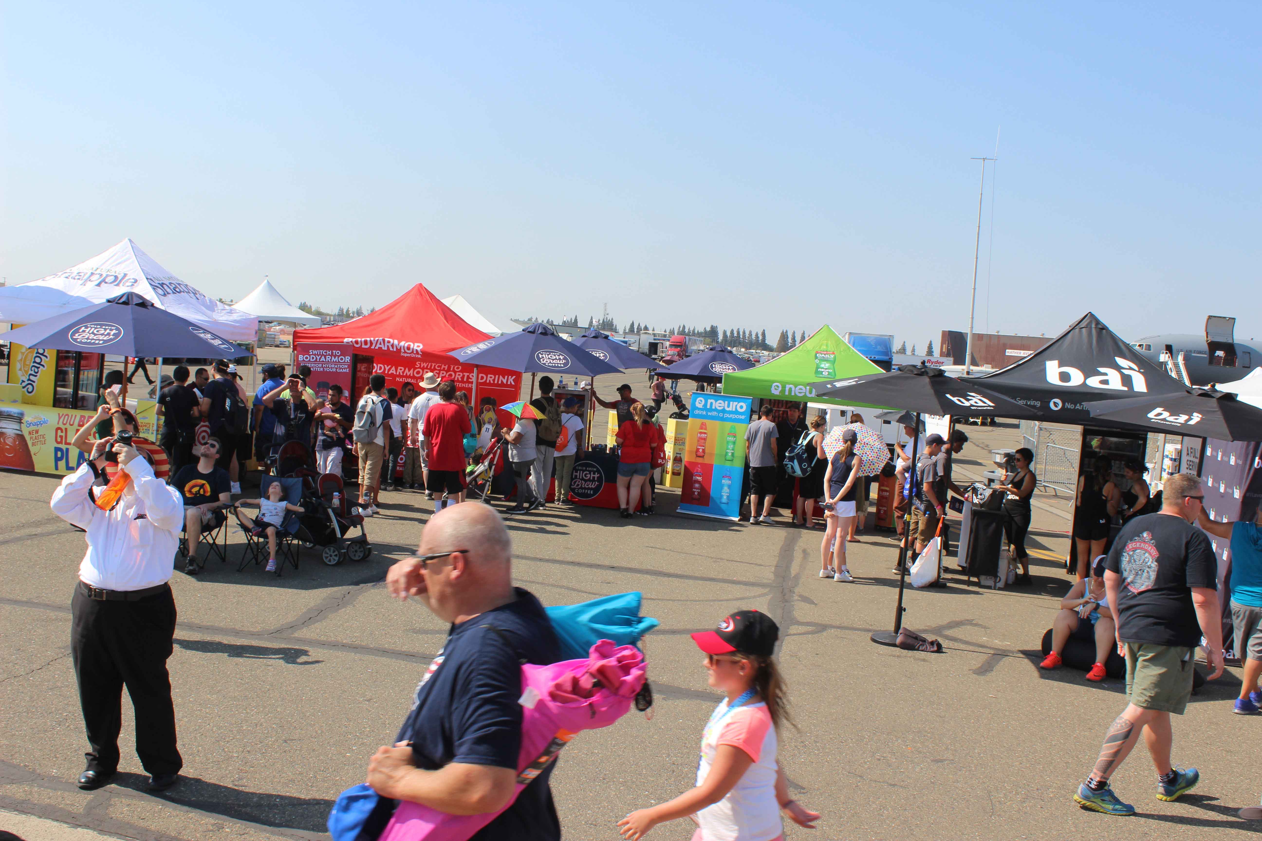 crowd visiting multiple exhibits at an air show